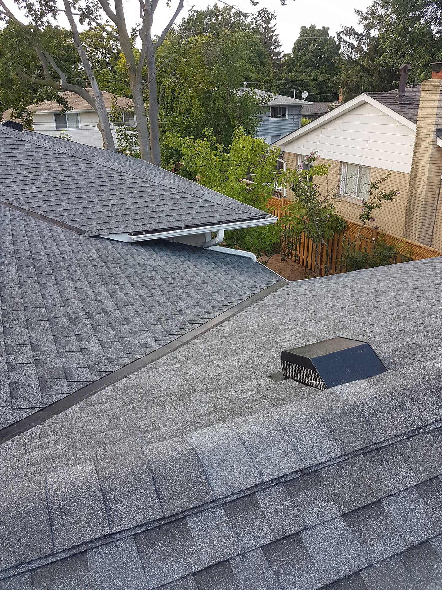 a newly installed grey roof with new metal vents